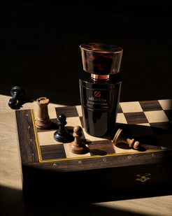 Black bottle Olfazeta by Chogan Millésime N°31 on a wooden chessboard surrounded by chess pieces