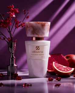 White bottle Olfazeta by Chogan Millésime N°57 on a purple background, red grapefruit and silver vase
