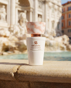 White bottle Olfazeta by Chogan Millésime N°49 in front of a baroque Roman fountain with turquoise water