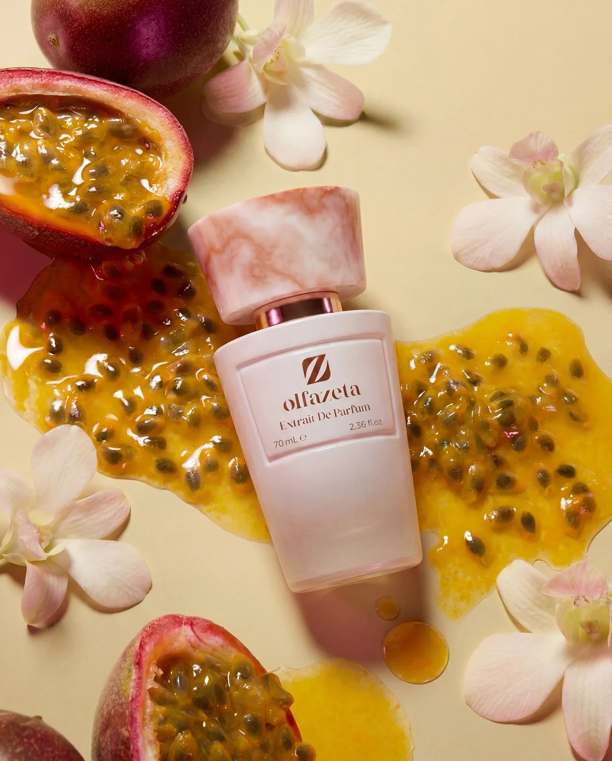 Pink bottle Olfazeta by Chogan Millésime N°71 surrounded by cut passion fruits and orchids